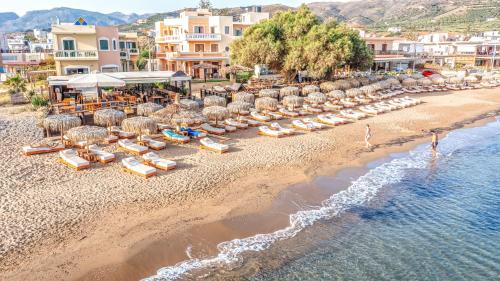 an aerial view of a beach with chairs and umbrellas at Maria Beach Hotel in Kissamos