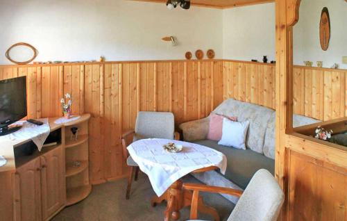 a living room with a table and a television at Ferienhaus Rechenberg in Rechenberg-Bienenmühle