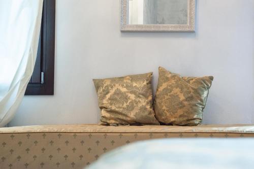 two pillows sitting on a couch in a room at Villa Gasparini in Dolo