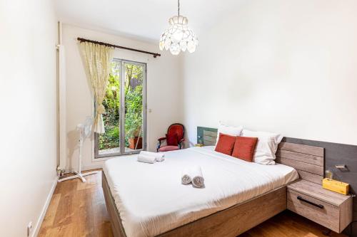 a bedroom with a large bed and a window at GuestReady - Prime haven in Montparnasse in Paris