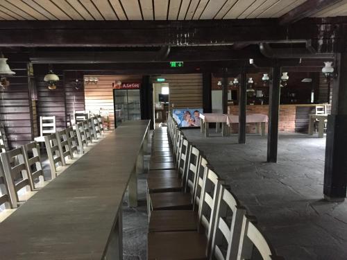 a long table with chairs in a restaurant at Sammuli Holiday Village in Viljandi