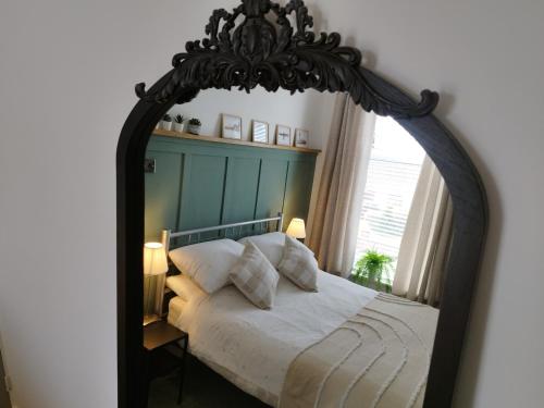 a bedroom with a large mirror over a bed at Mrs Seeleys House in Choppington