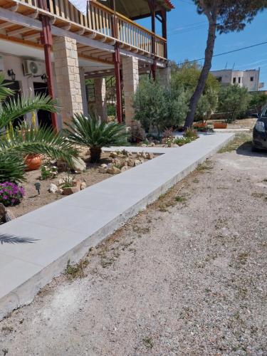 a concrete sidewalk in front of a house at Εmmi in Koutsounari