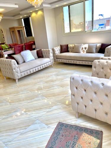 a living room with couches and a rug at شقة جديدة بالكامل in Port Said