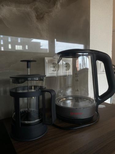 a black blender sitting on a wooden table at Filosoofi 1 Studio Apartments in Tartu