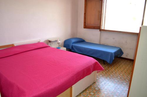 Ένα ή περισσότερα κρεβάτια σε δωμάτιο στο Casa Umi al primo piano per 7 pax