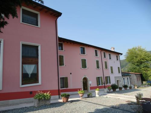 a pink building with plants in front of it at Agriturismo Corte Marani in Badia Calavena
