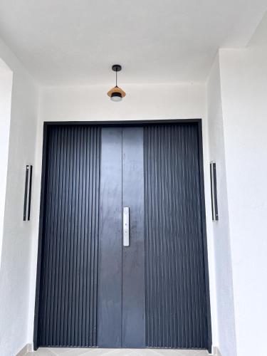 a door in a building with a light above it at RoomAH Sura Jetty in Kampong Pak Sabah
