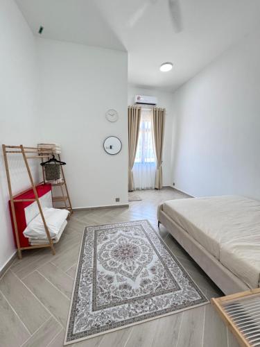 a bedroom with a bed and a rug on the floor at RoomAH Sura Jetty in Kampong Pak Sabah
