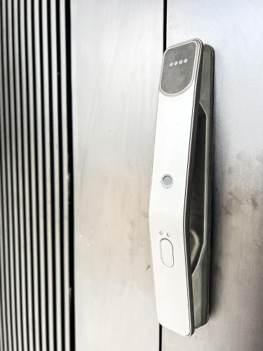 a cell phone is hanging on a wall at RoomAH Sura Jetty in Kampong Pak Sabah