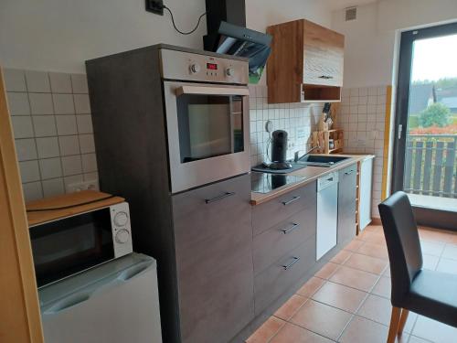 a kitchen with stainless steel appliances and a window at Ferienwohnung Hansi 