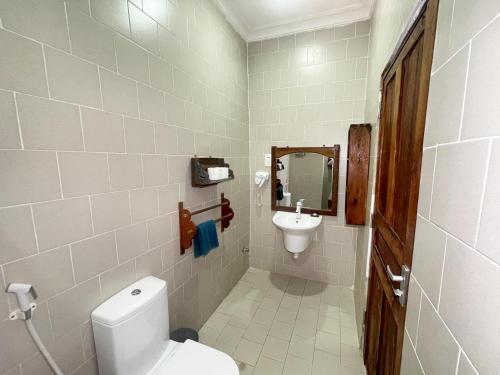 a small bathroom with a toilet and a sink at Aya Beach Resort in Kizimkazi