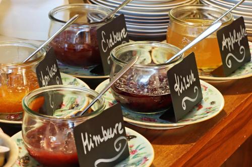 a display of food in jars on a table at Hotel Vorderburg in Schlitz