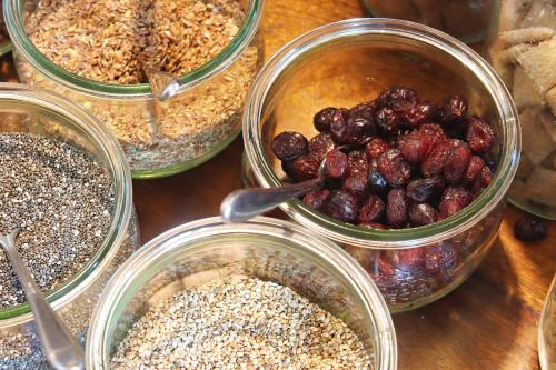 four jars of food with berries and oats on a table at Hotel Vorderburg in Schlitz