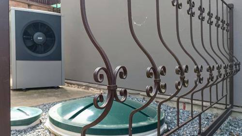 a iron fence in front of a washing machine at Guest House Prague Airport in Prague