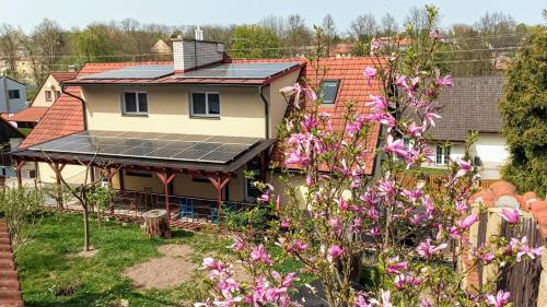 a house with solar panels on the roof at Guest House Prague Airport in Prague