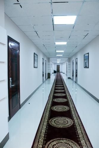an aisle in a hospital with a rug on the floor at Flamingo in Aktobe