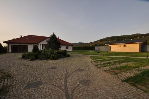 a driveway leading to a house and a house at Apartamenty Sowiogórskie in Pieszyce