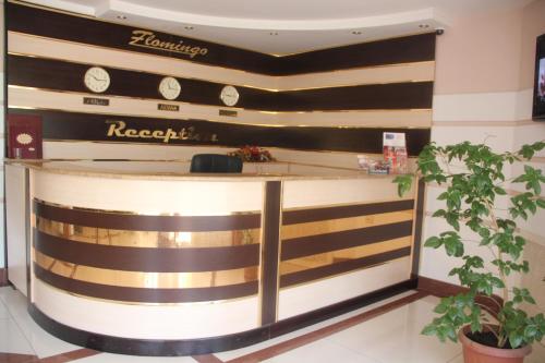 a lobby of a hotel with a reception counter at Flamingo in Aktobe