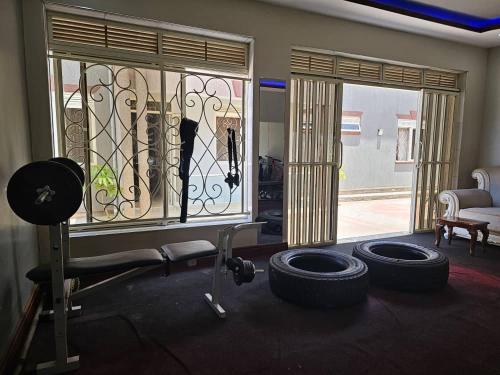 a room with a gym with two tires on the floor at HILLS APARTMENTS in Kampala