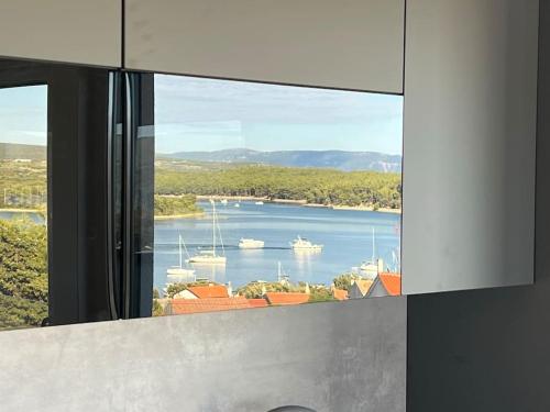 a view of a harbor from a window with boats in the water at Panorama Penthouse Punat in Punat