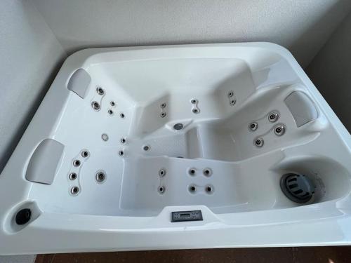 a white sink in a corner of a room at Panorama Penthouse Punat in Punat