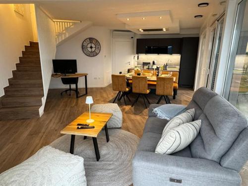 a living room with a couch and a table at Panorama Penthouse Punat in Punat