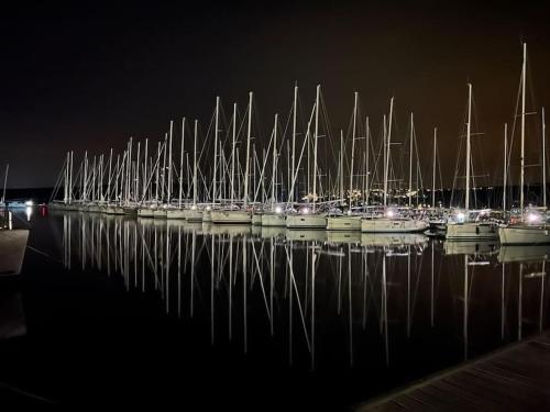 a bunch of boats parked in the water at night at Panorama Penthouse Punat in Punat