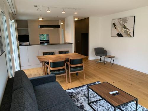 a living room with a couch and a table at Modern one bedroom flat close to the city - Bass1 in Bassersdorf