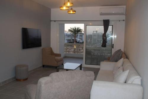 a living room with a couch and two chairs at Paradise Ras Sudr, Home in Raʼs Matarma