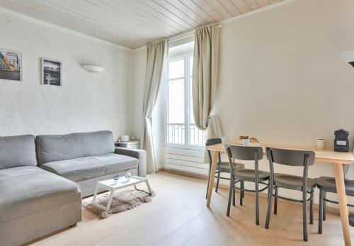 un salon avec un canapé et une table dans l'établissement GuestReady - Lovely Minimalist Studio in Plaisance, à Paris