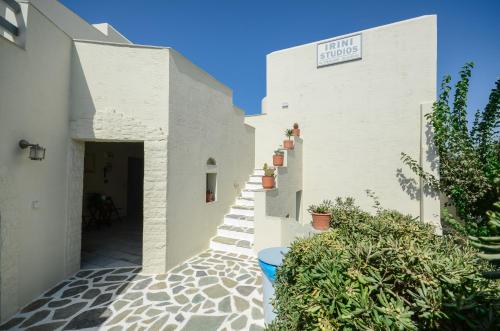 a white building with a sign that reads living studios at Irini Studios in Agia Anna Naxos