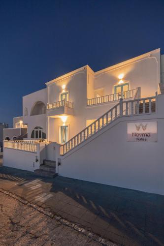 a white building with a staircase on it at night at Nevma Suites in Firostefani