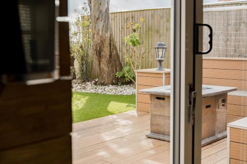 a door leading to a patio with a tree at Spacious & well decorated 4 bedroom home near Chester in Saughall