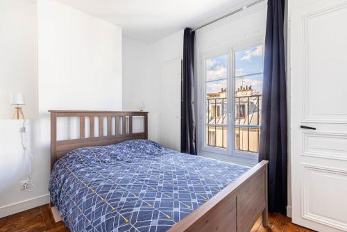 une chambre avec un lit et une fenêtre dans l'établissement GuestReady - Séjour Confortable près de Montmartre, à Paris
