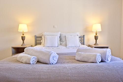a bedroom with two beds with pillows and two lamps at Apartamento moderno perto da marina e da praia in Lagos