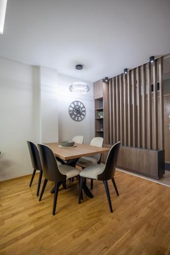 a dining room with a wooden table and chairs at M3 in Kraljevo