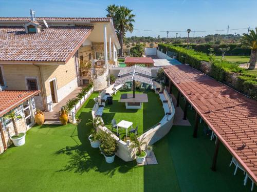 an overhead view of a house with a green yard at Re Sole Resort&Spa in Grottaglie
