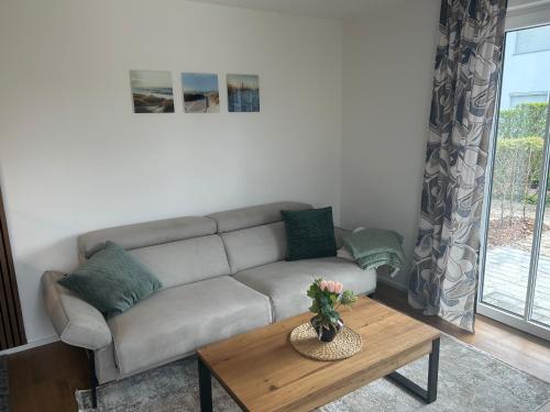 a living room with a couch and a coffee table at Ostseemöwe NEU in Zingst