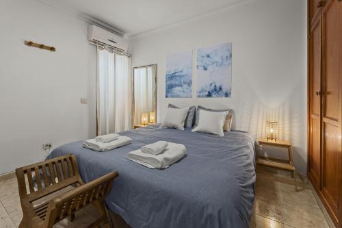 a bedroom with a large bed with two towels on it at Famara Power Apartment in Famara