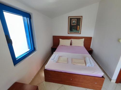 a small bedroom with a bed and a window at Glory Suites in Budva