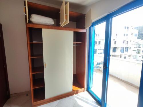 a room with a book shelf and a window at Glory Suites in Budva