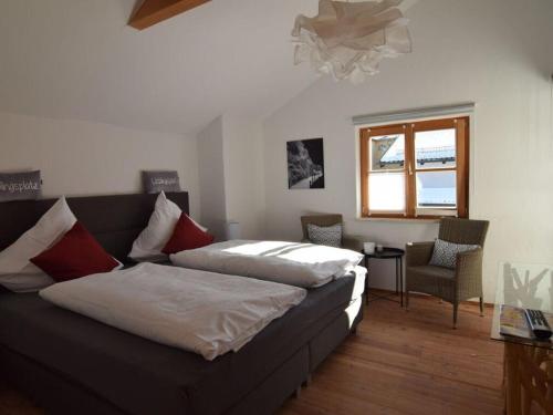 a bedroom with a couch and a chair and a window at Favorite place 1 in Garmisch-Partenkirchen