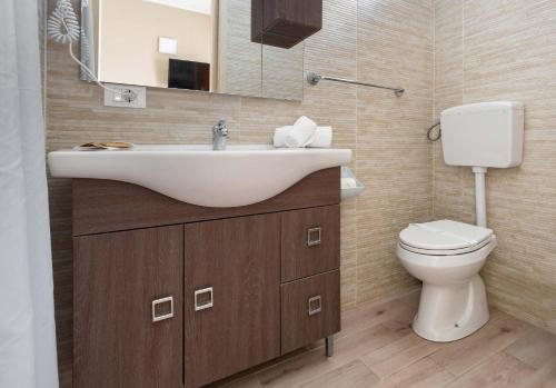a bathroom with a sink and a toilet at Re Sole Resort&Spa in Grottaglie