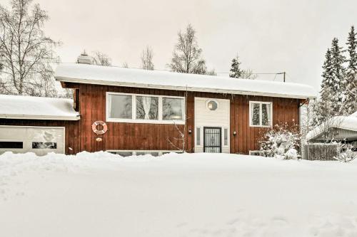 a house covered in snow with a driveway at West Anchorage Home Near Airport! home in Anchorage