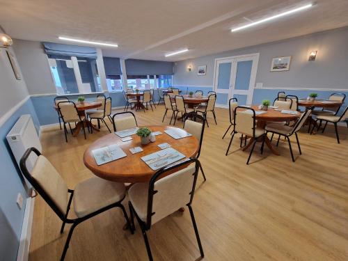 a conference room with tables and chairs in it at Burrowhead Holiday Village in Isle of Whithorn