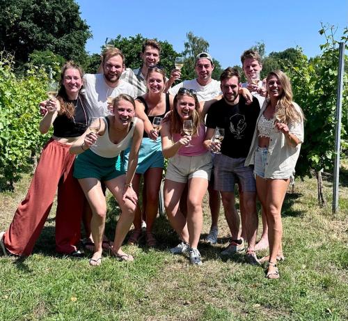 a group of people posing for a picture with wine glasses at Wijnstaete in Lemelerveld