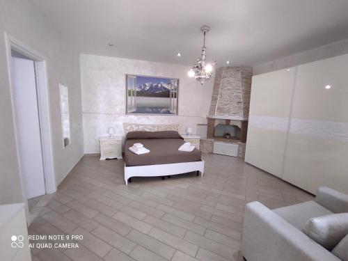 a bedroom with a bed and a couch and a fireplace at Re Sole Resort&Spa in Grottaglie