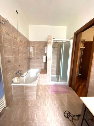 a bathroom with a tub and a shower and a sink at Giulietta Home in Belfiore