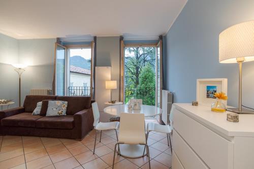 a living room with a couch and a table at Ossuccio Apt with Balcony & Private Parking in Ossuccio